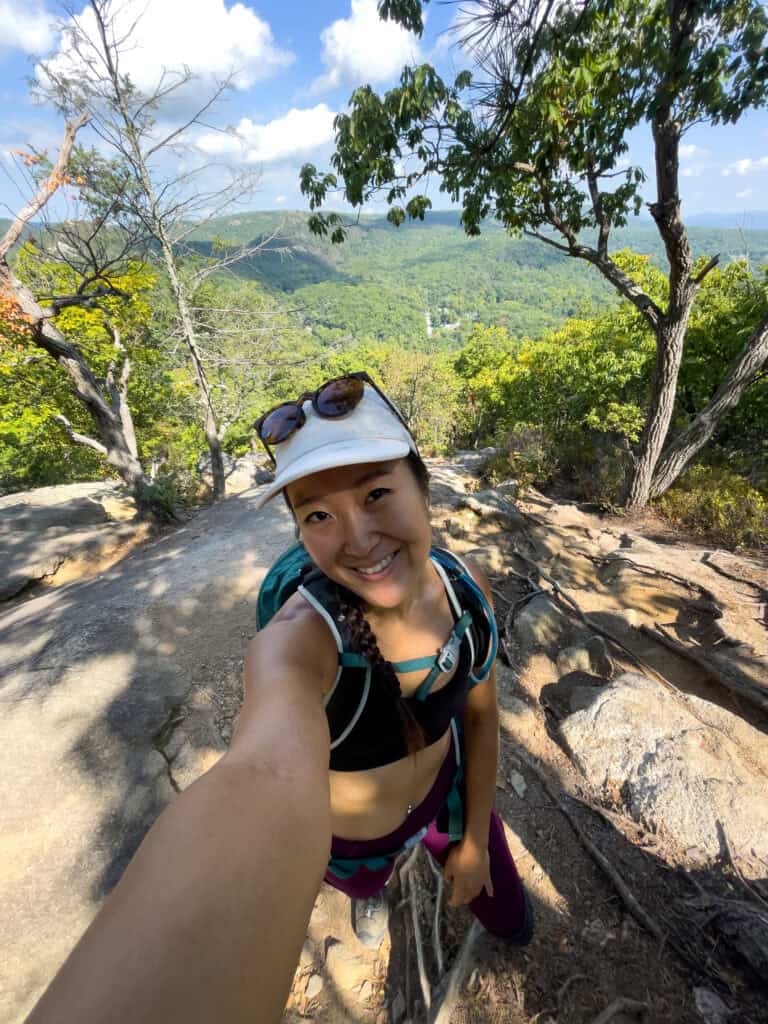 korean american girl on rocky portion of bear mountain loop hike day trip from nyc without a car hikes by train from nyc